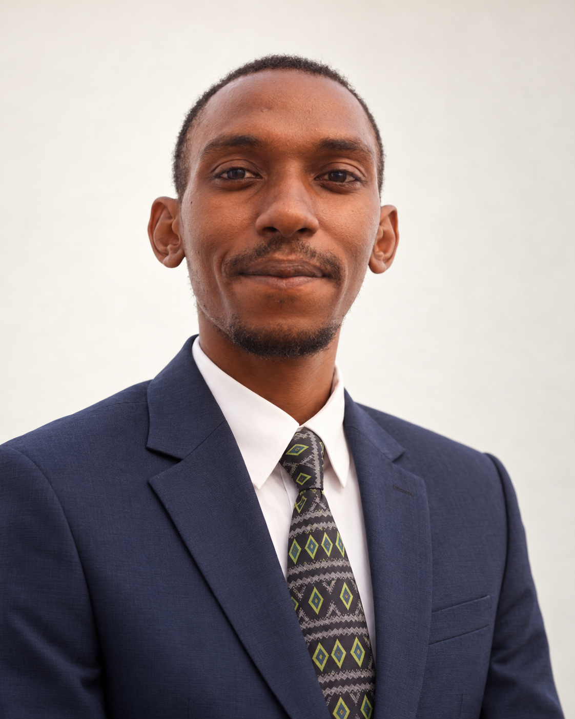 Formal portrait of Counsel Musinguzi Eriot in a navy suit